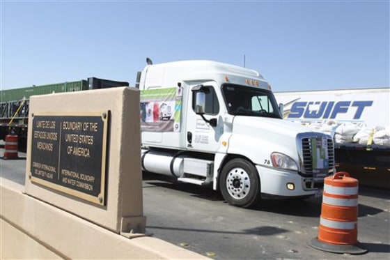 A Mexican truck crosses the border between Mexico and the United States in Nuevo Laredo, Mexico, Friday, for the first time under the North American Free Trade Agreement.